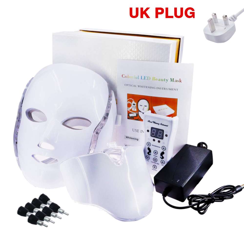 The image displays a Photon Facial LED Light Therapy Mask, its packaging box, manual, and a UK plug type. The mask is designed to treat various skin conditions with its seven different color LEDs built-in, including wrinkles, acne, and pigmentation. The packaging box and manual provide instructions for usage and the UK plug type is included for power supply.